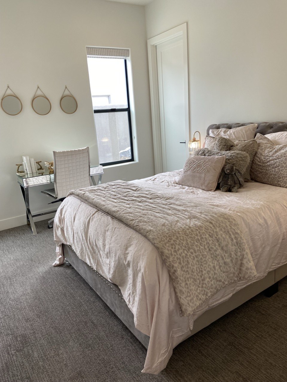 Beautiful bedroom with tufted headboard and vanity